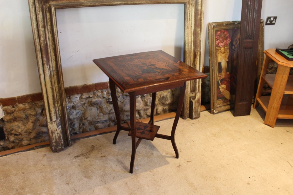 A square Victorian side table featuring geometric star-patterned specimen wood marquetry, curved legs, and a matching central undertier. View III