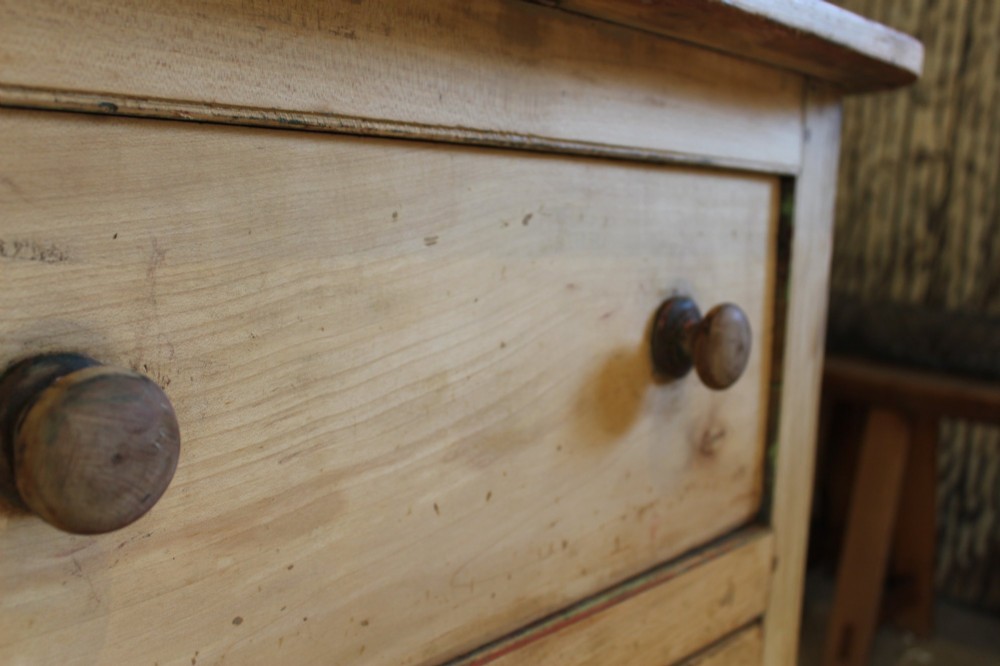 A George III scrubbed pine kneehole desk featuring four side drawers with turned wood handles and an arched central opening. View V