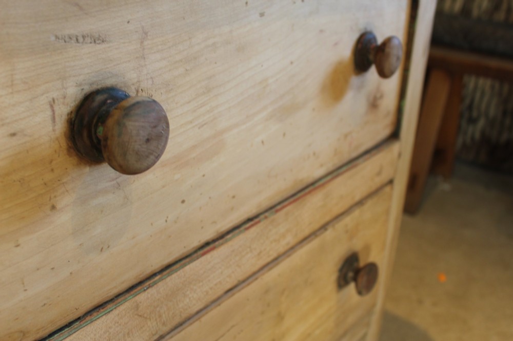 A George III scrubbed pine kneehole desk featuring four side drawers with turned wood handles and an arched central opening. View VII