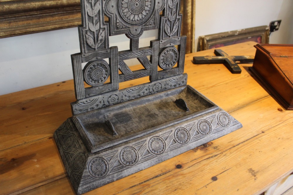 A Victorian cast iron stick stand featuring intricate geometric lattice patterns, a central floral rosette medallion, and a brass top rail over a rectangular drip tray. View III