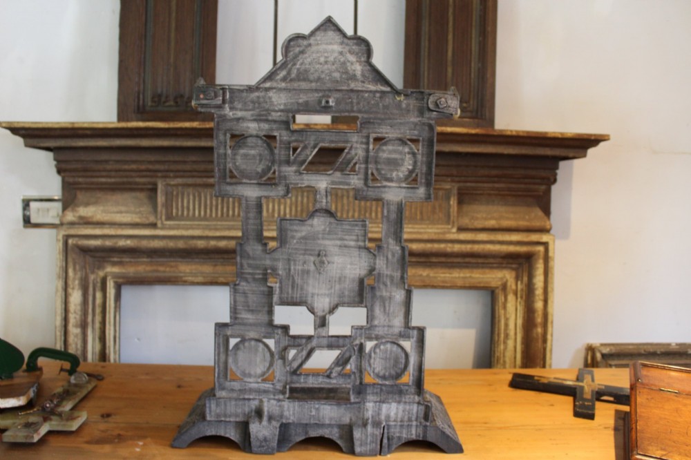 A Victorian cast iron stick stand featuring intricate geometric lattice patterns, a central floral rosette medallion, and a brass top rail over a rectangular drip tray. View XII