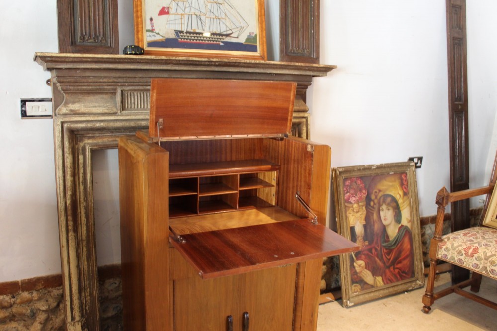 An Art Deco walnut bureau featuring a fall-front writing compartment above a single drawer and a two-door cupboard. View IV