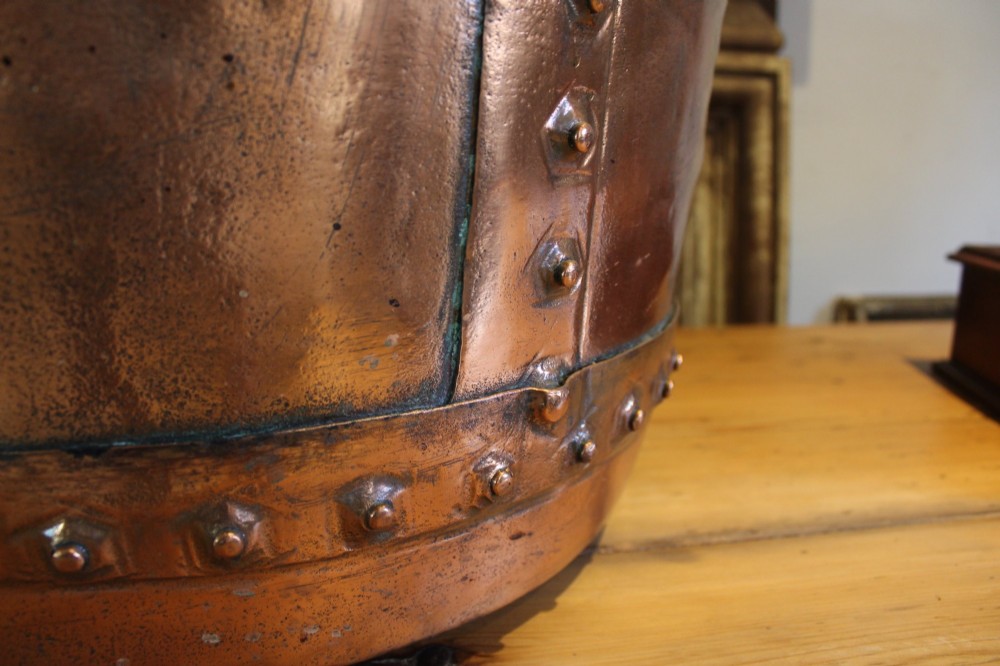 A large nineteenth-century Victorian copper vessel featuring a flared rolled rim and a hand-riveted vertical seam. View IV