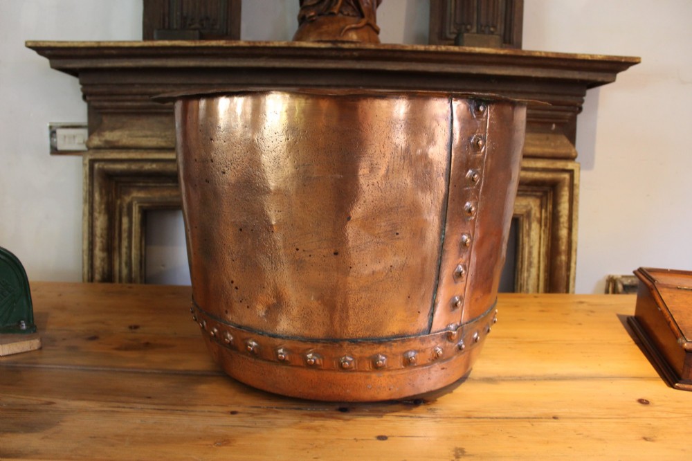 A large nineteenth-century Victorian copper vessel featuring a flared rolled rim and a hand-riveted vertical seam. View VI
