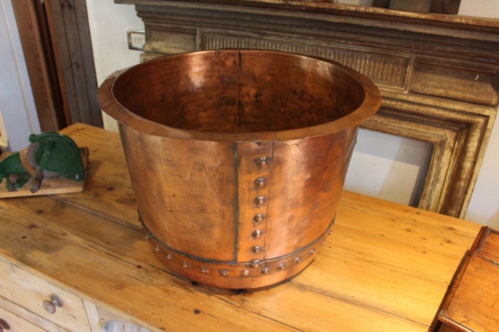 A large nineteenth-century Victorian copper vessel featuring a flared rolled rim and a hand-riveted vertical seam. View IX