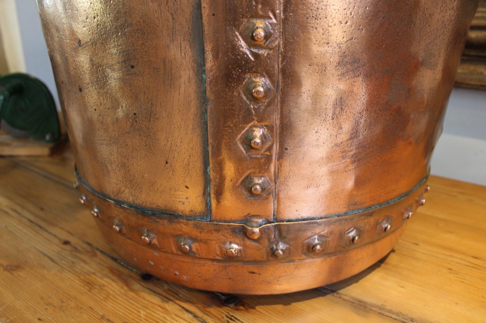 A large nineteenth-century Victorian copper vessel featuring a flared rolled rim and a hand-riveted vertical seam. View X