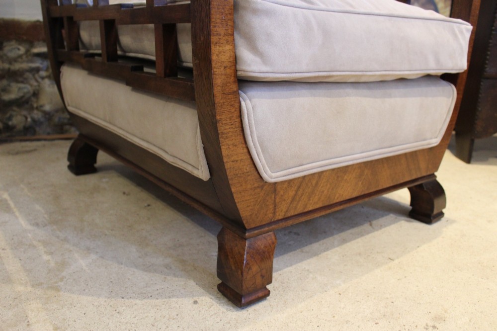 An Art Deco solid walnut armchair featuring grid-pattern side panels, squared feet, and beige suede seat and back cushions. View II
