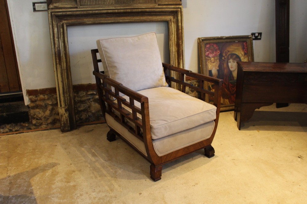 An Art Deco solid walnut armchair featuring grid-pattern side panels, squared feet, and beige suede seat and back cushions. View IX