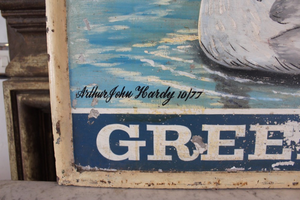 A double-sided rectangular painted metal pub sign depicting a white swan floating on blue water with White Swan text above and Greene King text below. View III