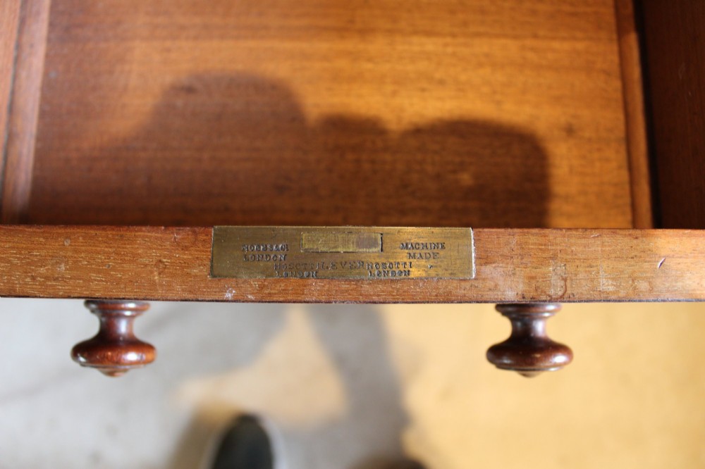 An early Victorian mahogany partners desk featuring a black leather writing top, twin pedestals with multiple drawers, and turned wooden handles. View II