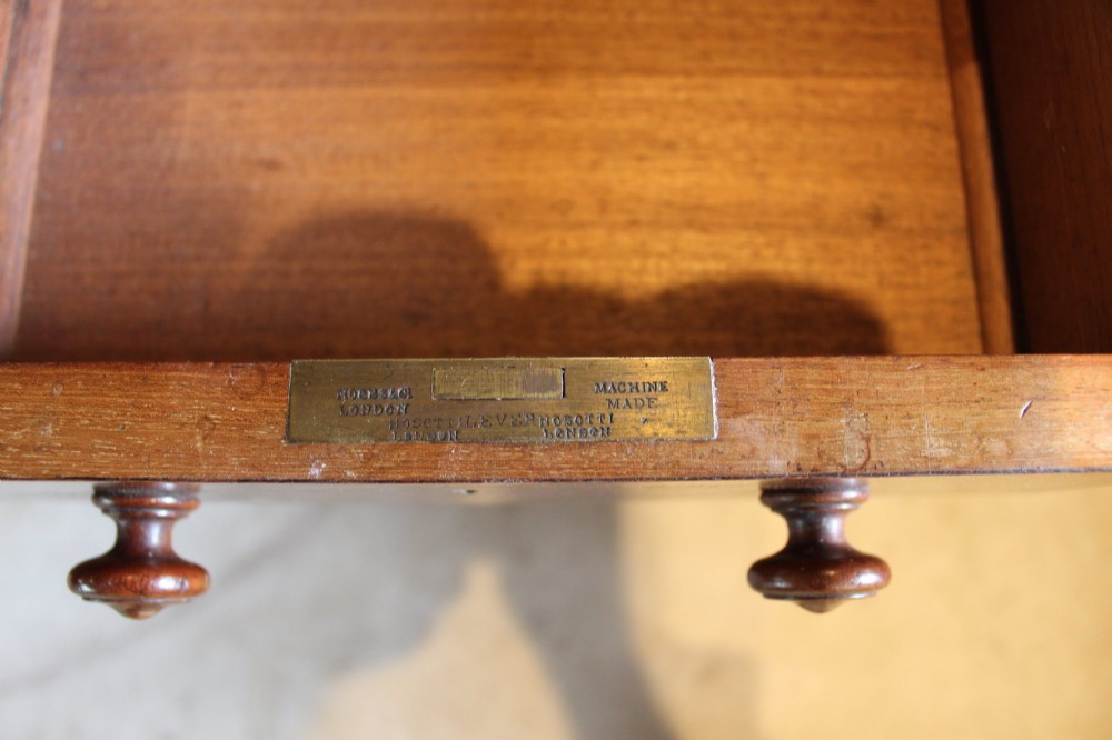 An early Victorian mahogany partners desk featuring a black leather writing top, twin pedestals with multiple drawers, and turned wooden handles. View VIII