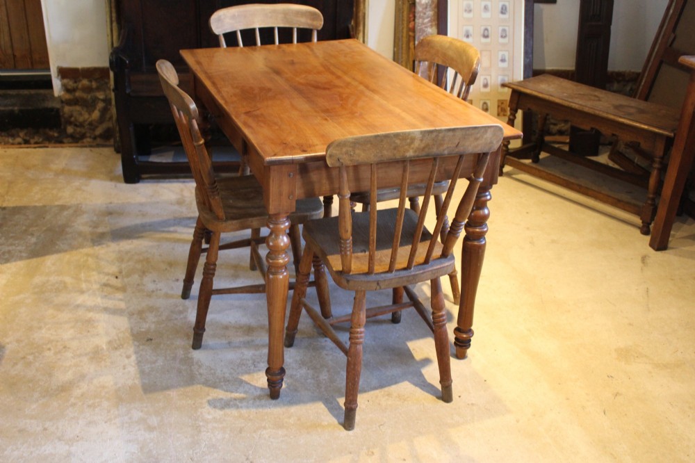 A rectangular French cherry wood dining table featuring four turned legs and a single frieze drawer. View II