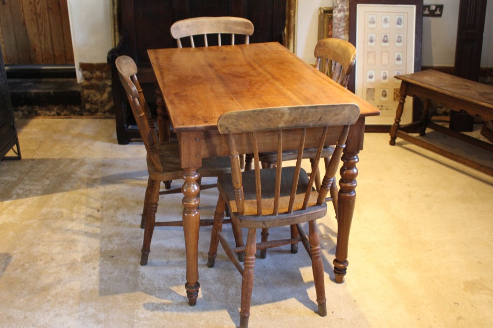 A rectangular French cherry wood dining table featuring four turned legs and a single frieze drawer. View XI