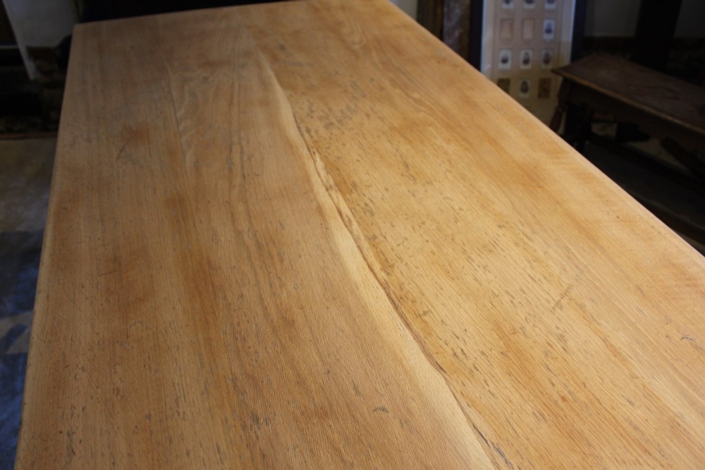 An Edwardian light oak farmhouse refectory dining table featuring straight square legs and a spacious rectangular plank top. View IV