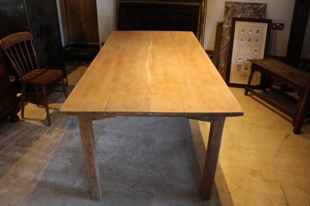 An Edwardian light oak farmhouse refectory dining table featuring straight square legs and a spacious rectangular plank top. View VI