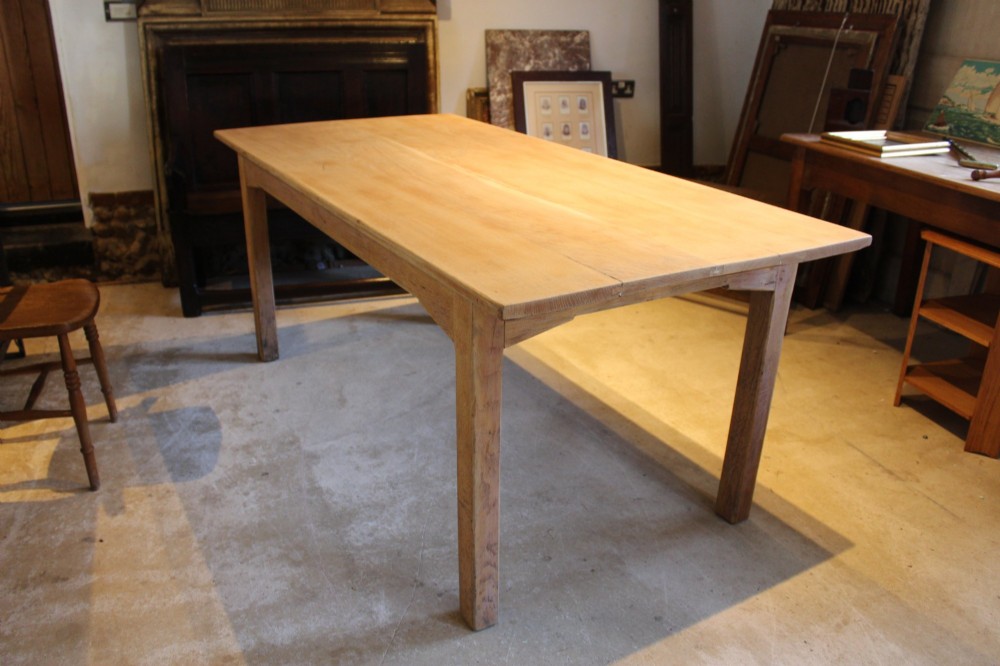 An Edwardian light oak farmhouse refectory dining table featuring straight square legs and a spacious rectangular plank top. View IX