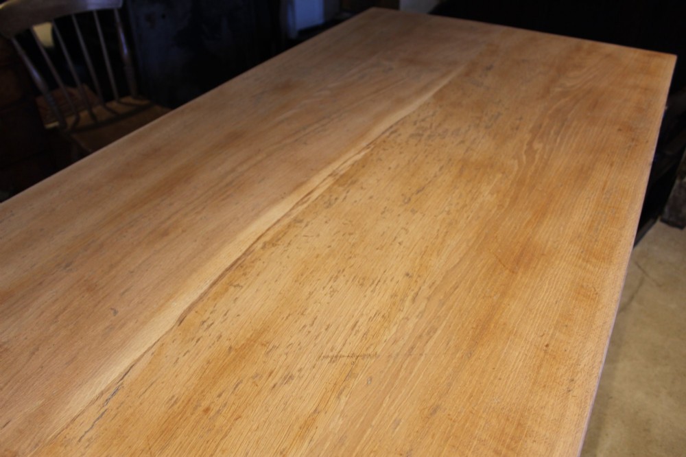 An Edwardian light oak farmhouse refectory dining table featuring straight square legs and a spacious rectangular plank top. View X