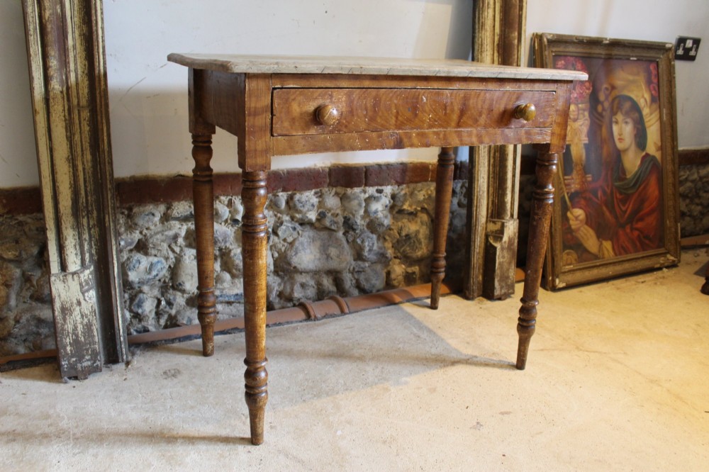 A mid-19th-century Victorian side table with a single drawer, turned legs, turned wooden knobs, and an authentic warm brown scumble glaze finish. View VIII