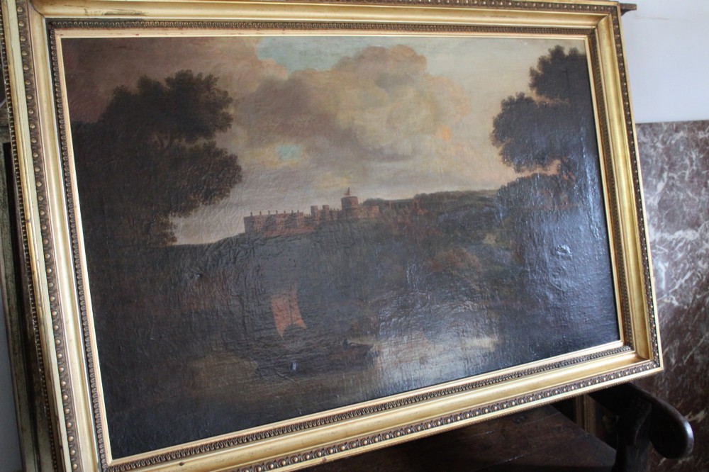 A large 18th-century oil painting on canvas depicting a landscape view of Windsor Castle across a river with a small sailing vessel, held in a beaded giltwood frame. View III