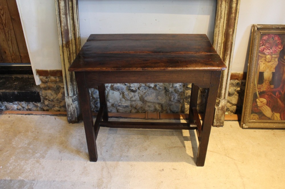 A dark oak George I side table featuring a rectangular plank top, pegged mortise and tenon joinery, and square legs joined by lower stretchers. View II