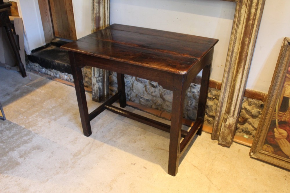 A dark oak George I side table featuring a rectangular plank top, pegged mortise and tenon joinery, and square legs joined by lower stretchers. View III