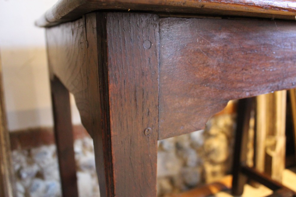 A dark oak George I side table featuring a rectangular plank top, pegged mortise and tenon joinery, and square legs joined by lower stretchers. View IV