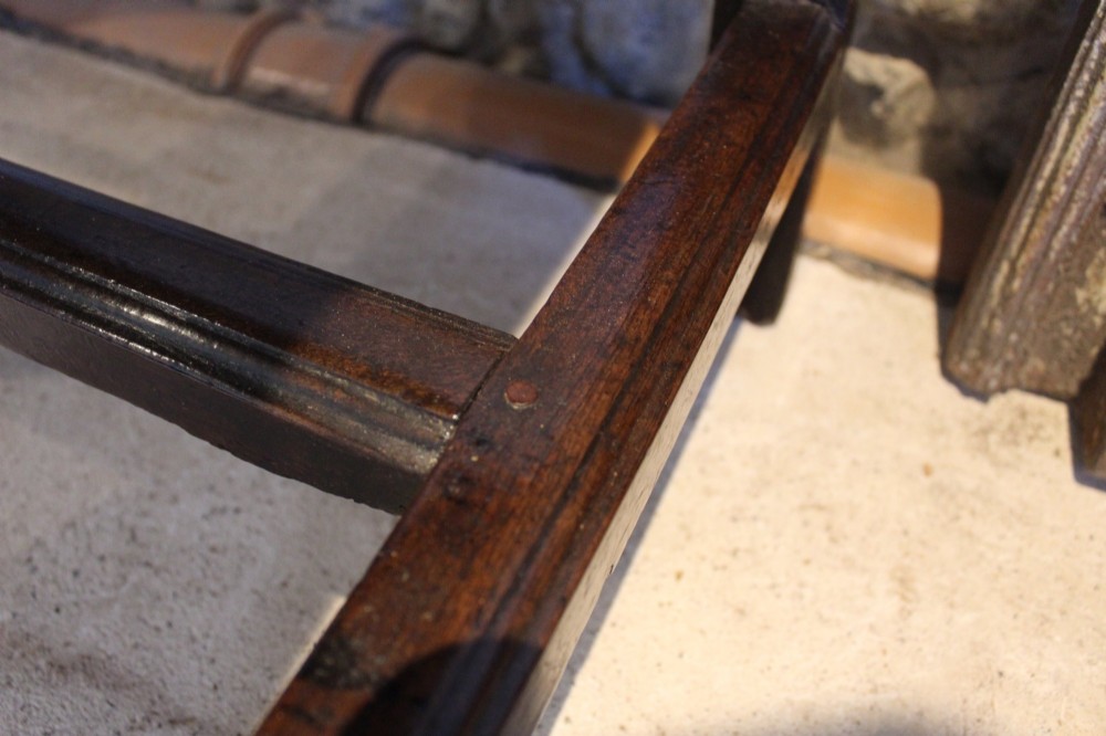 A dark oak George I side table featuring a rectangular plank top, pegged mortise and tenon joinery, and square legs joined by lower stretchers. View VIII
