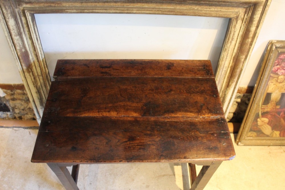 A dark oak George I side table featuring a rectangular plank top, pegged mortise and tenon joinery, and square legs joined by lower stretchers. View X