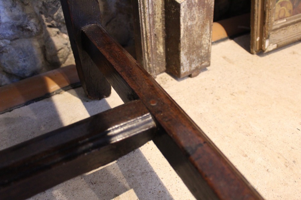 A dark oak George I side table featuring a rectangular plank top, pegged mortise and tenon joinery, and square legs joined by lower stretchers. View XI