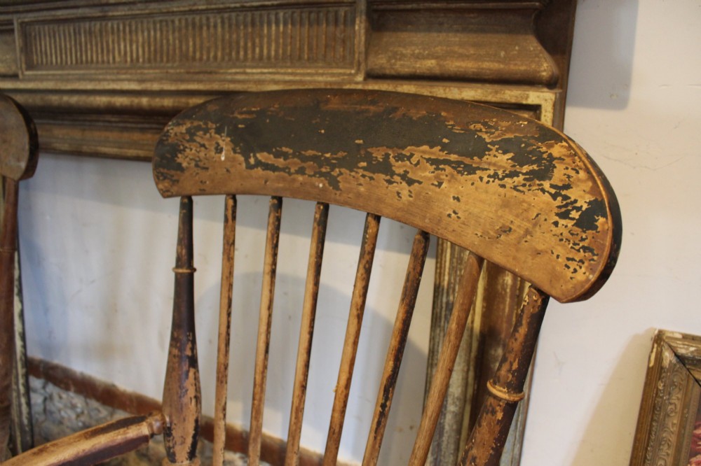 A pair of late 19th-century Windsor armchairs featuring shaped elm seats, spindle backs, turned legs, and distressed dark brown patinated finish. View IV