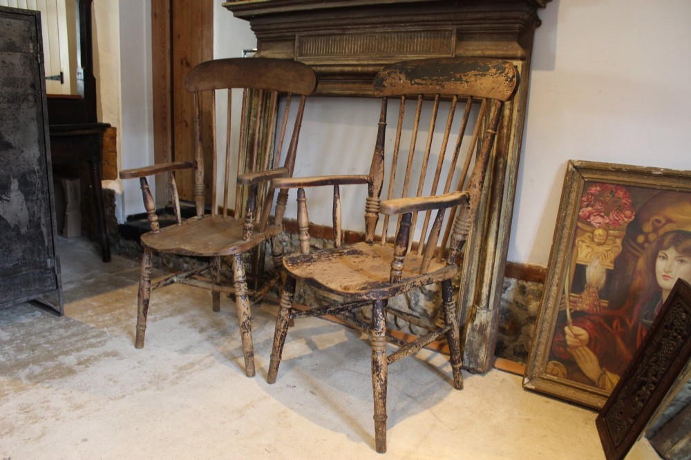 A pair of late 19th-century Windsor armchairs featuring shaped elm seats, spindle backs, turned legs, and distressed dark brown patinated finish. View VIII