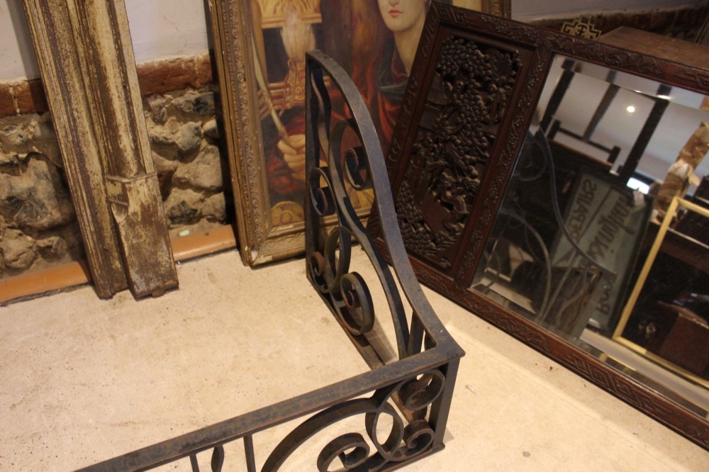 A large dark steel fire fender featuring decorative scrolling ironwork along the front and side returns. View VIII