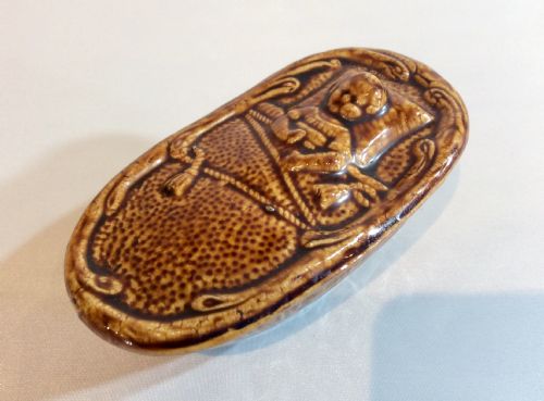 rare treacle glaze french money bank in the form of a child in bed - CATEGORY: ANTIQUE BOXES - DATED 1920