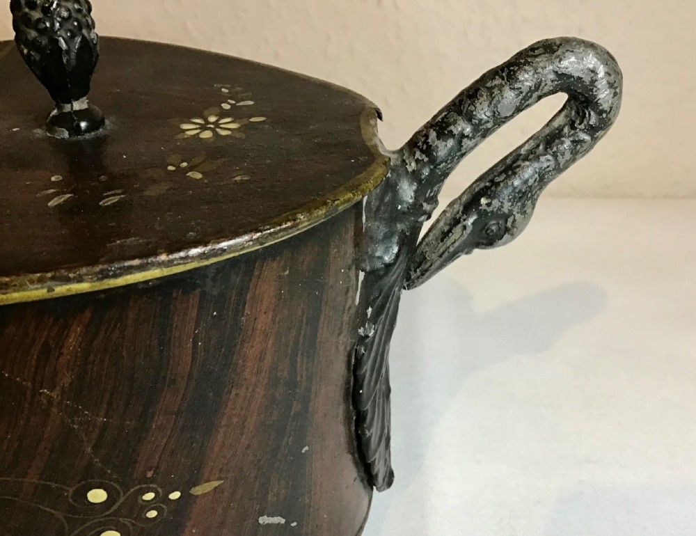 A dark brown oval wooden egg coddler featuring floral bone inlay, side handles, four metal feet, and three pinecone finials on the split lid. View XI