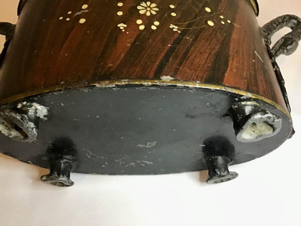 A dark brown oval wooden egg coddler featuring floral bone inlay, side handles, four metal feet, and three pinecone finials on the split lid. View XIV