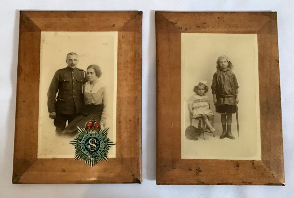 A pair of early twentieth-century framed studio portrait photographs showing a soldier with a woman on the left, and two young girls on the right.