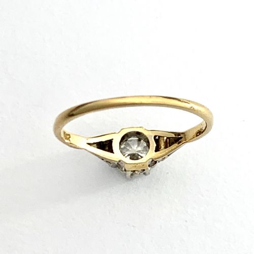 fig 1. A vintage 18ct yellow gold solitaire ring displaying a single round diamond held in platinum claws with geometric shoulders.