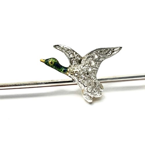 fig 1. An Edwardian 15ct gold bar brooch featuring a flying duck set with diamonds and green enamel details.