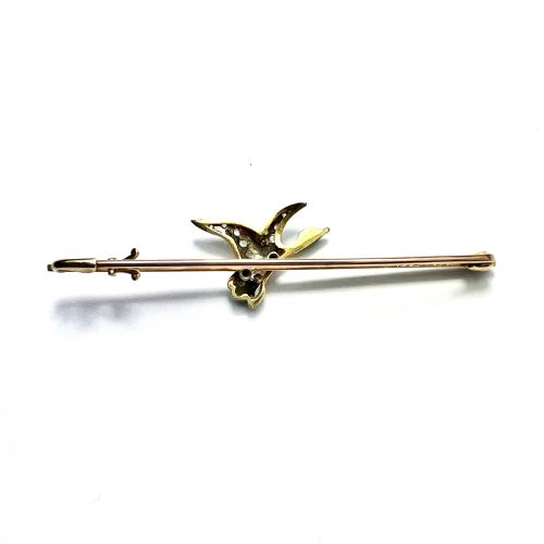fig 2. An Edwardian 15ct gold bar brooch featuring a flying duck set with diamonds and green enamel details.