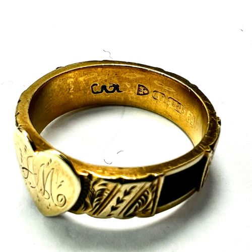 fig 1. An Edwardian yellow gold ring featuring a central heart motif engraved with a monogram and shoulders decorated with chased scroll patterns.