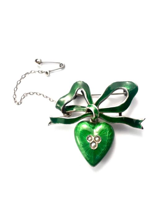 fig 1. An antique silver brooch featuring a green translucent enamel ribbon bow with a hanging green enamel heart drop set with three small seed pearls.