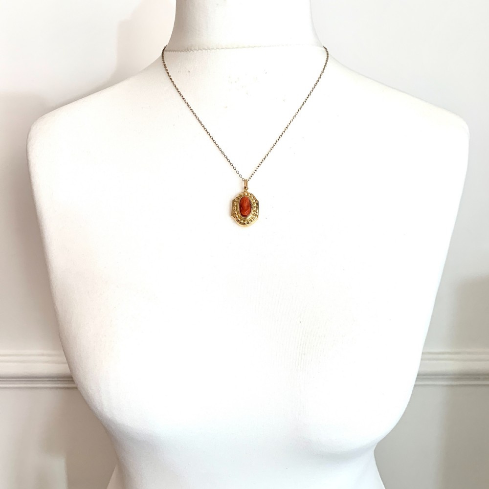 An oval Victorian 18ct gold pendant featuring an orange-red carved coral cameo classical bust framed by a beaded gold border. View IX