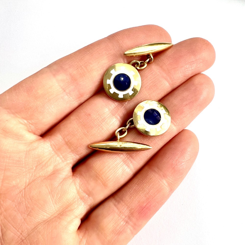 A pair of antique 18ct yellow gold chain-link cufflinks featuring circular faces decorated with central blue enamel discs surrounded by white enamel borders and connected to torpedo-shaped backs. View VI