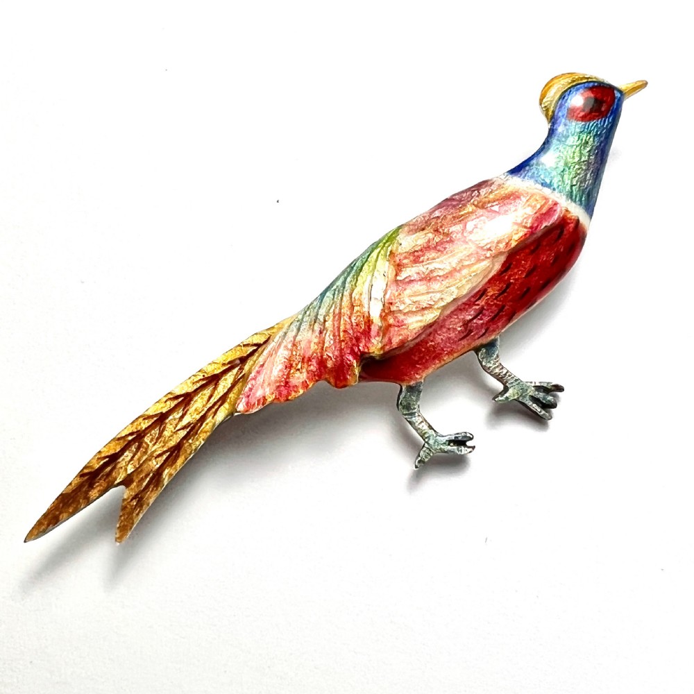 An Art Deco silver brooch shaped like a standing pheasant featuring red, green, blue, and gold enamel detailing. View V