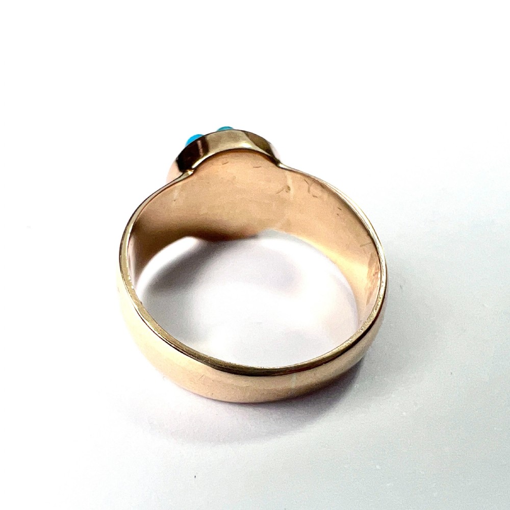 A Victorian 18ct yellow gold ring featuring a central round panel set with turquoise cabochons forming an eight-pointed star motif. View IV