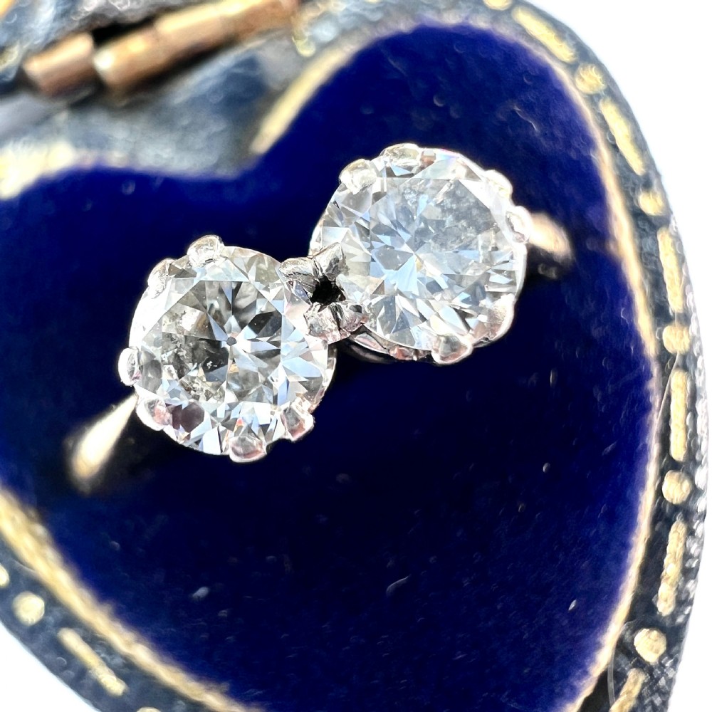 A vintage Toi et Moi ring featuring two round diamonds in platinum settings on an 18ct yellow gold band. View II