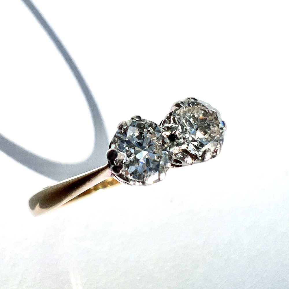 A vintage Toi et Moi ring featuring two round diamonds in platinum settings on an 18ct yellow gold band. View III