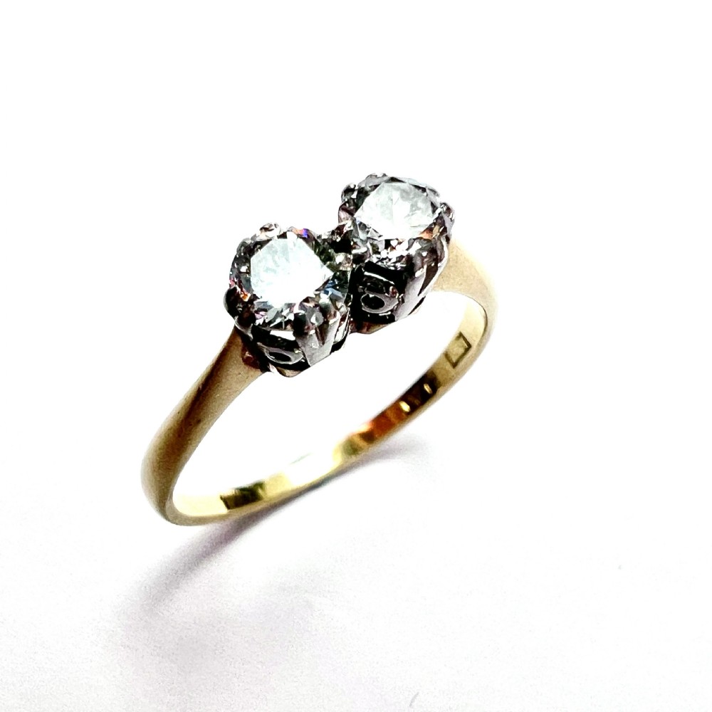 A vintage Toi et Moi ring featuring two round diamonds in platinum settings on an 18ct yellow gold band. View IV