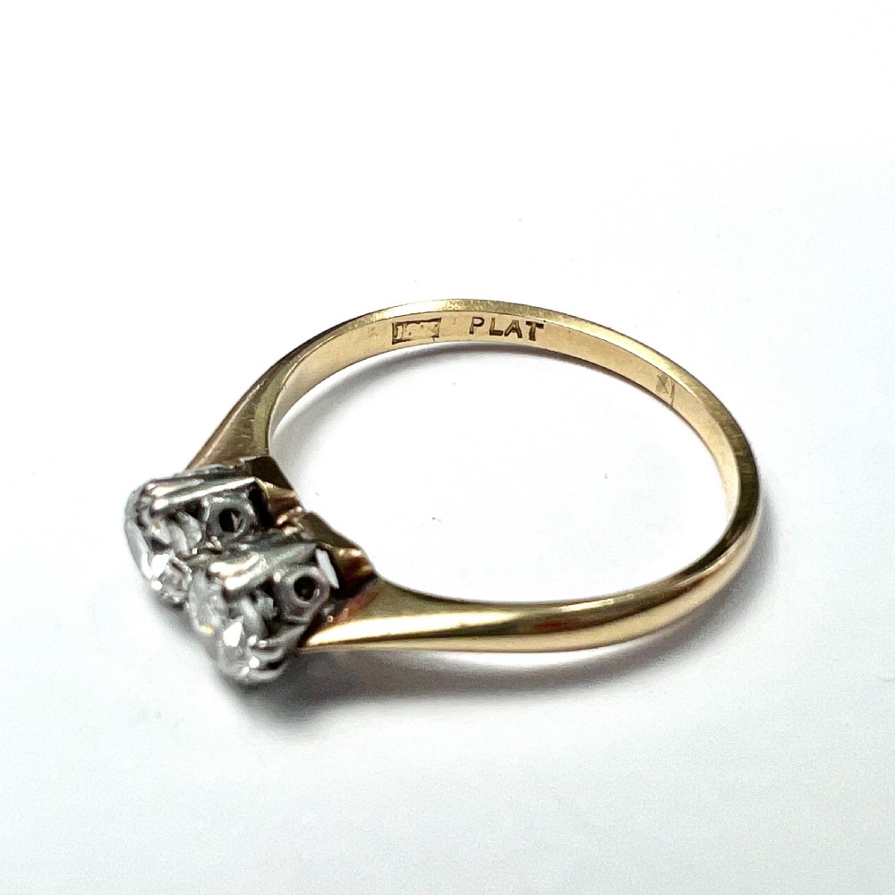 A vintage Toi et Moi ring featuring two round diamonds in platinum settings on an 18ct yellow gold band. View V