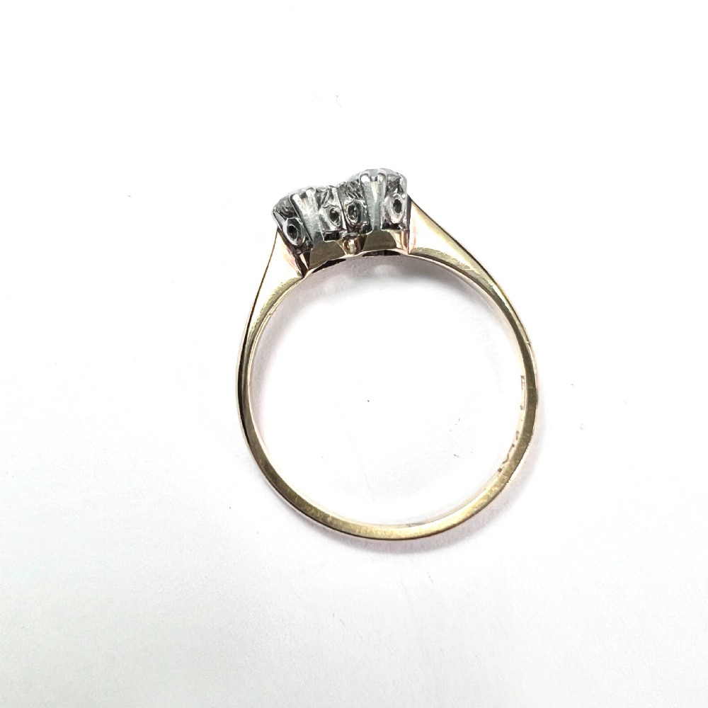 A vintage Toi et Moi ring featuring two round diamonds in platinum settings on an 18ct yellow gold band. View VI